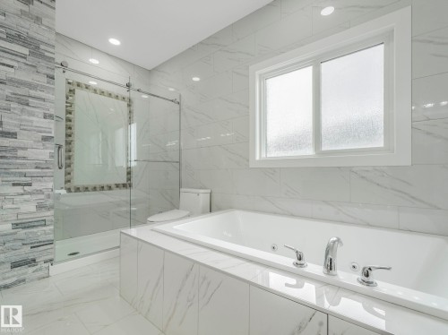 Soaking tub with integrated jets and polished chrome fixtures - 3101 Pelerin Crescent, Beaumont, AB 