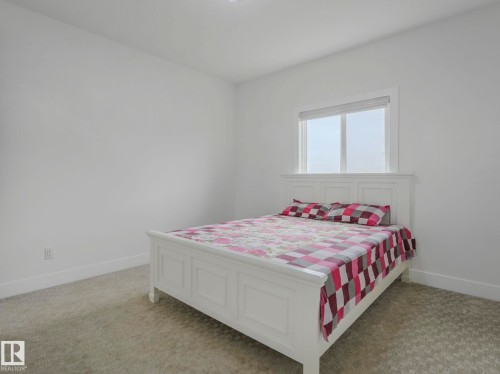 Bright bedroom with white walls and baseboards - 3101 Pelerin Crescent, Beaumont, AB 