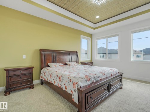 Tray ceiling with recessed lighting and a decorative central fixture - 3101 Pelerin Crescent, Beaumont, AB 