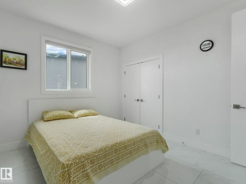 Bright room featuring a prominent window, white walls, and large format tile flooring - 3101 Pelerin Crescent, Beaumont, AB 