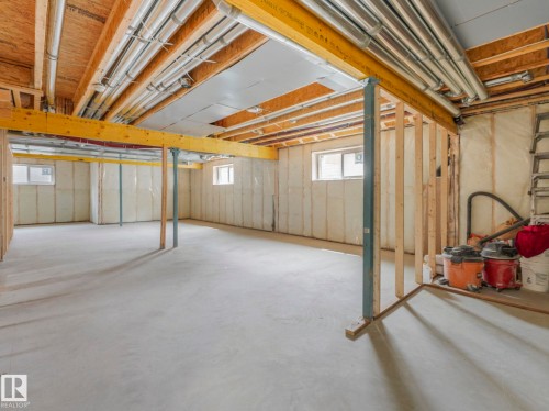 Unfinished basement featuring a concrete floor, exposed wood joists, and visible utility conduits - 3101 Pelerin Crescent, Beaumont, AB 