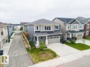 Contemporary two-story residence featuring a two-car garage, concrete driveway, and a small front lawn - 2031 207 Street, Edmonton, AB 