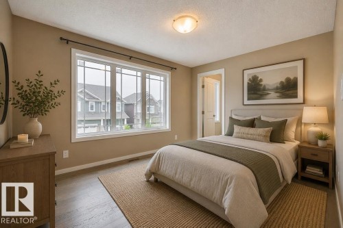 Spacious room featuring wood-finish flooring, a large window with mullions, and a flush-mount ceiling light. Virtually Staged Photos - 2031 207 Street, Edmonton, AB 