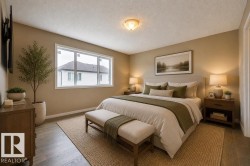 Bedroom featuring wood-finish flooring, a contemporary window, and a ceiling-mounted light fixture. Virtually Staged Photos - 