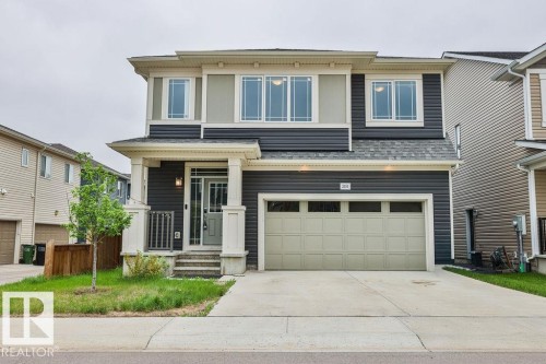 Two-story residential exterior featuring dark gray siding and light beige trim - 2031 207 Street, Edmonton, AB 