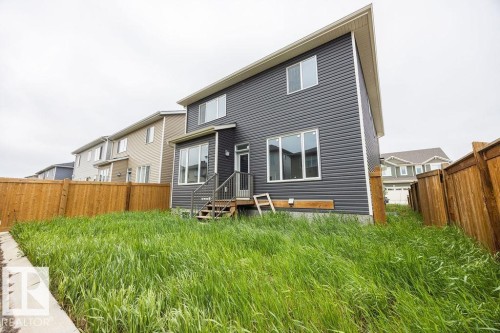 Contemporary two-story residence featuring dark horizontal siding and a light soffit - 2031 207 Street, Edmonton, AB 