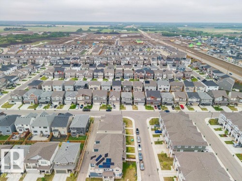Expansive neighborhood featuring a variety of detached homes and townhomes, concrete streets, and a developing landscape - 2031 207 Street, Edmonton, AB 