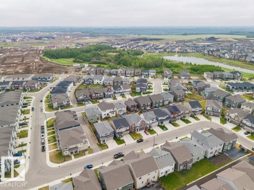 Aerial perspective of a developed residential area with numerous detached houses featuring varied exterior finishes and rooflines - 2031 207 Street, Edmonton, AB 