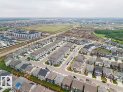 Aerial perspective showcasing a modern residential community with a mix of detached homes and attached townhomes - 