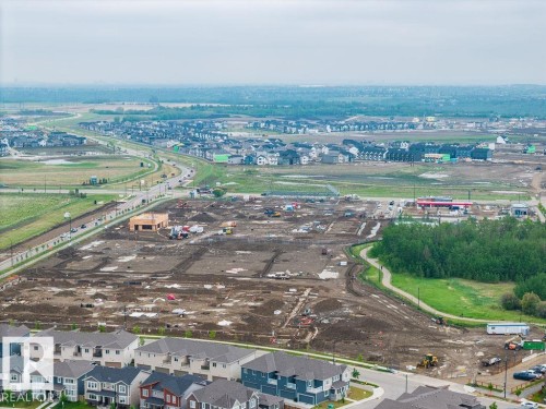 Developing residential area featuring established homes, active construction sites, and infrastructure development - 2031 207 Street, Edmonton, AB 