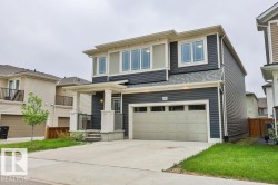 Two-story residence featuring dark gray horizontal siding and contrasting light trim - 