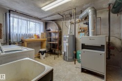Utility area featuring a laundry sink, washing machine, and a window with natural light - 