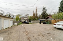 Two-car detached garage with white garage doors - 