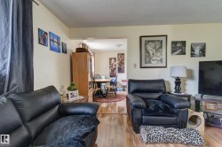 Expansive room featuring wood-finish flooring and neutral wall tones - 