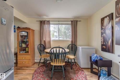 Open-concept dining area featuring wood-finish flooring - 9749 88 Avenue, Edmonton, AB - Indoor