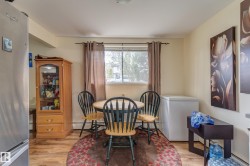 Open-concept dining area featuring wood-finish flooring - 