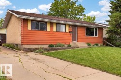 Exterior features a brown shingle roof, orange horizontal siding, and stucco accents - 