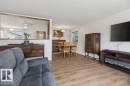 Open-concept living area featuring wood-finish flooring throughout - 123 Grandin Drive, Morinville, AB 
