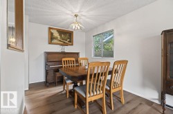 Dining area featuring wood-finish flooring, white walls, and a recessed window - 