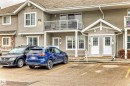 Multi-unit residential exterior featuring horizontal siding and stone veneer accents - 53 150 Edwards Drive, Edmonton, AB 