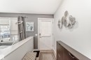 Entryway featuring a white door with integrated blinds, tile flooring, and light gray walls - 53 150 Edwards Drive, Edmonton, AB 