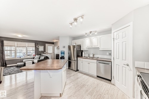Open-concept living space featuring wood-finish flooring - 53 150 Edwards Drive, Edmonton, AB 