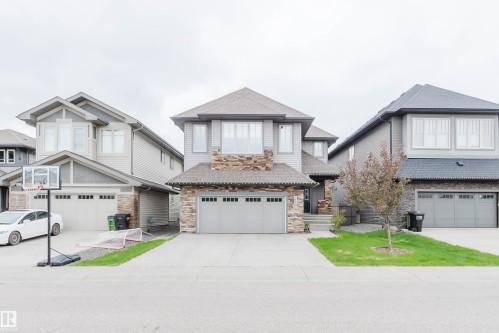 Two-story residential architecture featuring a stone and siding exterior - 1957 Ainslie Link, Edmonton, AB 