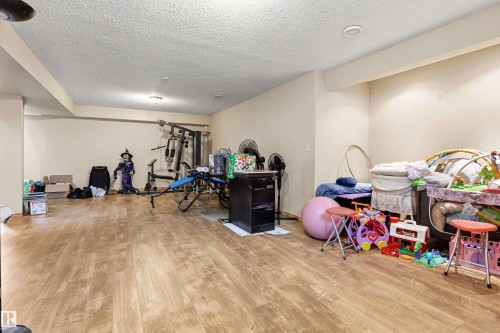 Spacious lower level featuring wood-finish flooring, recessed lighting, and light-toned walls - 32 Lamplight Bay, Spruce Grove, AB 