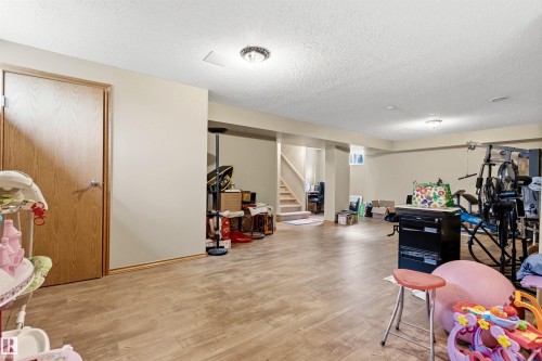 Spacious lower level featuring wood-finish flooring, neutral wall tones, and recessed lighting - 32 Lamplight Bay, Spruce Grove, AB 