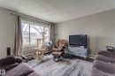 Living area featuring light gray wall paint and dark wood-finish flooring - 10524 78 Street, Edmonton, AB  - Indoor Photo Showing Living Room 