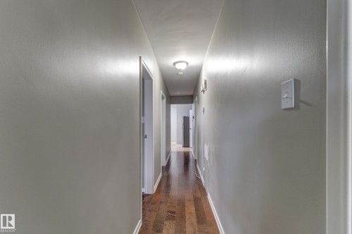 Hallway featuring wood-finish flooring and light gray painted walls - 10524 78 Street, Edmonton, AB - Indoor Photo Showing Other Room