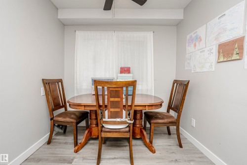 Compact dining area featuring light gray walls and wood-finish flooring - 3103 109 Street, Edmonton, AB 