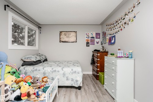 Light gray walls complement the wood-finish flooring in this room - 3103 109 Street, Edmonton, AB 