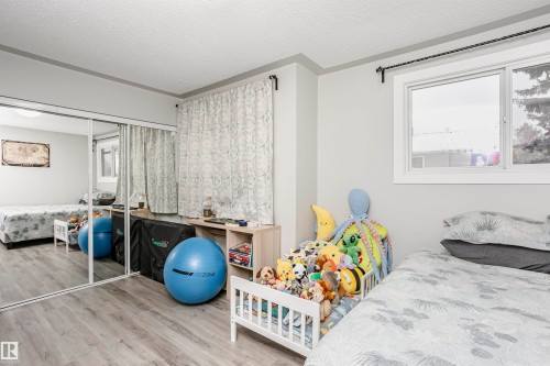 Room featuring wood-finish flooring and light gray walls - 3103 109 Street, Edmonton, AB 