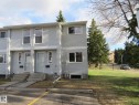 Gray siding exterior with white window trim and white entry doors - 3103 109 Street, Edmonton, AB 