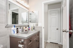 Bathroom vanity with a gray countertop, an integrated sink, and dark wood-finish cabinetry - 