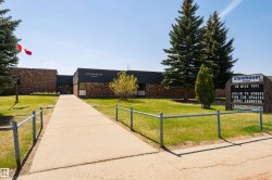 Brick and dark facade building with a prominent entrance - 