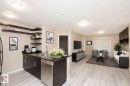 Open-concept living space featuring wood-finish flooring - 108 530 Watt Boulevard, Edmonton, AB 