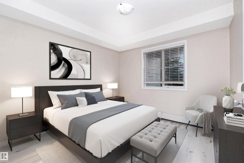 Spacious bedroom featuring light-toned walls and wood-finish flooring - 108 530 Watt Boulevard, Edmonton, AB 