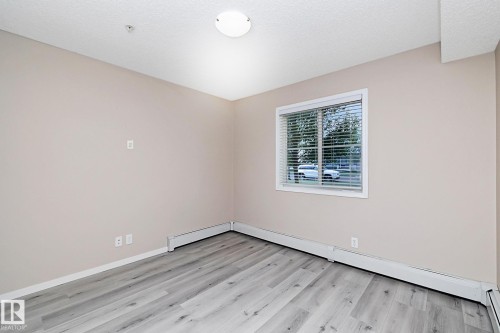 Neutral-toned walls complement the wood-finish flooring - 108 530 Watt Boulevard, Edmonton, AB 