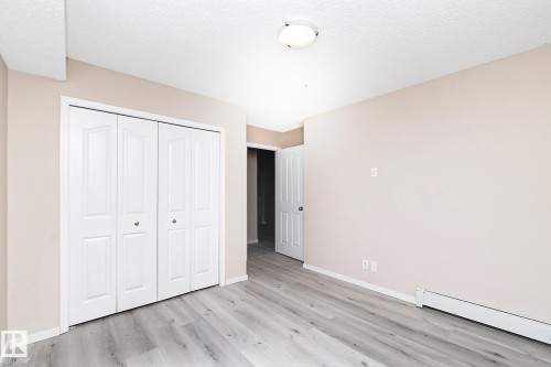 Room featuring light-toned walls and wood-finish flooring - 108 530 Watt Boulevard, Edmonton, AB 