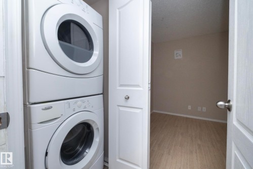 Dedicated laundry area featuring a stacked washer and dryer unit - 108 530 Watt Boulevard, Edmonton, AB 