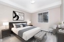 Spacious bedroom featuring light-toned walls and wood-finish flooring - 108 530 Watt Boulevard, Edmonton, AB 