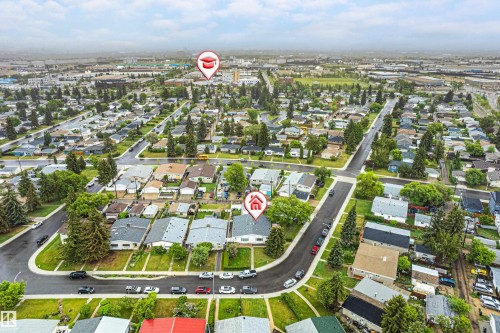 Aerial perspective of a residential neighborhood featuring tree-lined streets and numerous single-family homes - 9011 60 Street, Edmonton, AB 