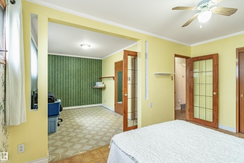 Room featuring light yellow walls and crown molding - 9011 60 Street, Edmonton, AB 