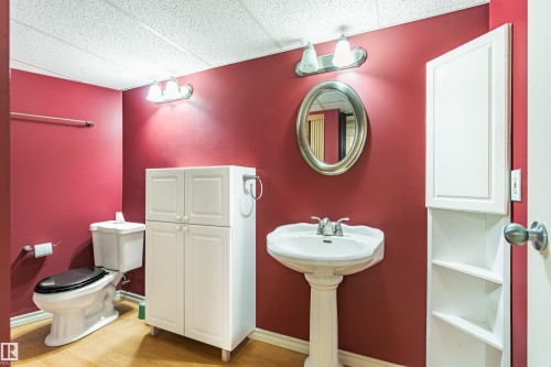 Pedestal sink with chrome faucet and oval mirror - 9011 60 Street, Edmonton, AB 