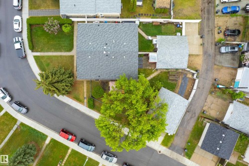 Property featuring a shingle roof, established landscaping, and a paved driveway - 9011 60 Street, Edmonton, AB 