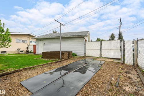 Detached garage with white siding and gray shingle roof - 9011 60 Street, Edmonton, AB 