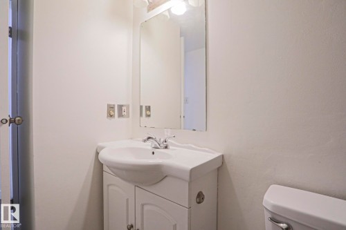 White vanity with an integrated sink and chrome faucet - 205 14903 92 Avenue Nw, Edmonton, AB 