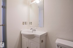 White vanity with an integrated sink and chrome faucet - 